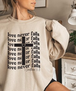 Love Never Fails Christian T-Shirt with Bible Verse and Cross Design
