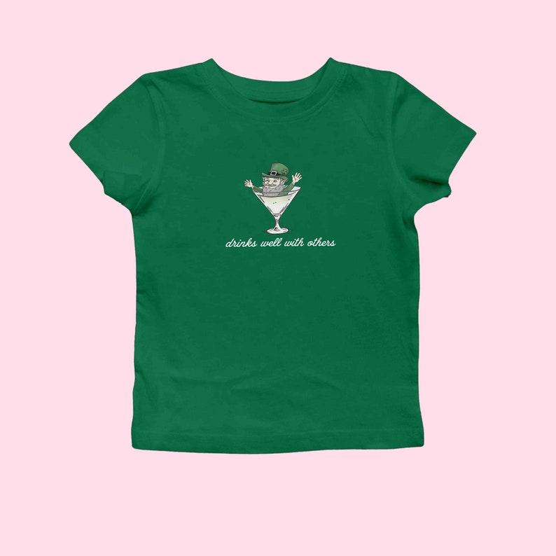 St. Patrick's Day Baby Tee for Women - Leprechaun Martini Cocktail Shirt with a Fun Twist